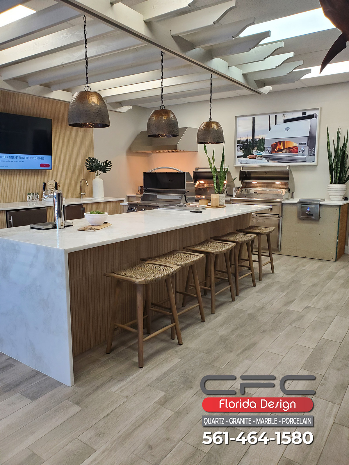 Outdoor kitchen with grills and a waterfall island
